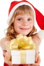 girl with present wearing a santa hat