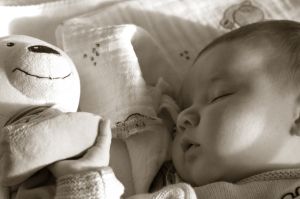 sleeping child with teddy