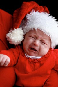 crying baby in a santa outfit